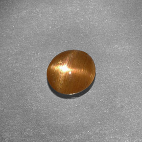 0.79克拉天然棕色星光日光石，椭圆形切割，6.9×6.4毫米，不透明