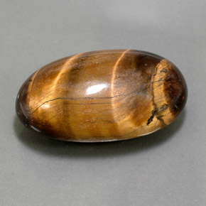 26.13克拉天然棕色Tiger's Eye，椭圆形切割，24.8×15.3毫米，不透明
